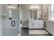 Modern bathroom featuring a glass-enclosed shower and a sleek vanity with black hardware at 7625 Breeze Bay Rd, Cumming, GA 30041