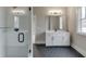 Modern bathroom features a glass-enclosed shower, sleek vanity with storage, and hexagon tile flooring at 7625 Breeze Bay Rd, Cumming, GA 30041