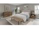 Serene bedroom with neutral decor, natural wood accents, and plenty of natural light at 7625 Breeze Bay Rd, Cumming, GA 30041
