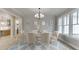 Formal dining room featuring elegant wainscoting, chandelier, and natural light at 7625 Breeze Bay Rd, Cumming, GA 30041