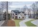 Stunning exterior view of brick home with a long driveway and mature trees at 7625 Breeze Bay Rd, Cumming, GA 30041