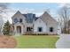 Beautiful two-story brick home with a manicured lawn and welcoming entrance at 7625 Breeze Bay Rd, Cumming, GA 30041