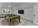 Entertaining game room features a pool table and comfortable seating area, perfect for Gathering fun at 7625 Breeze Bay Rd, Cumming, GA 30041