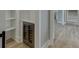 Hallway featuring a modern beverage cooler, white shelving, light hardwood floors, and recessed lights at 7625 Breeze Bay Rd, Cumming, GA 30041