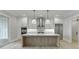 Bright kitchen featuring marble counters, modern cabinets, stainless steel appliances, and a kitchen island at 7625 Breeze Bay Rd, Cumming, GA 30041