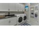 Well-organized laundry room with ample storage and modern washer and dryer at 7625 Breeze Bay Rd, Cumming, GA 30041