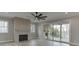 Spacious living room featuring a modern fireplace, large sliding doors to the outside, and a ceiling fan at 7625 Breeze Bay Rd, Cumming, GA 30041