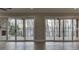 Spacious living room with hard wood floors, sliding glass doors to the outside, and a view of the water at 7625 Breeze Bay Rd, Cumming, GA 30041