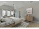 Serene primary bedroom with vaulted ceiling, natural light, and stylish decor at 7625 Breeze Bay Rd, Cumming, GA 30041