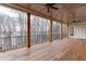 A spacious covered patio with wood columns offering a serene view of the lake at 7625 Breeze Bay Rd, Cumming, GA 30041