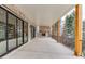 Covered patio featuring a brick fireplace, columns, and expansive views at 7625 Breeze Bay Rd, Cumming, GA 30041