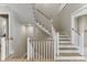Elegant staircase with wood and white railing, providing access to multiple levels of the home at 7625 Breeze Bay Rd, Cumming, GA 30041