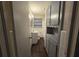 Bathroom features a toilet, sink, vanity, overhead light, and built-in cabinet at 767 Vinson Pl, Atlanta, GA 30315