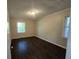 Cozy bedroom features hardwood floors, neutral walls, and windows providing natural light at 767 Vinson Pl, Atlanta, GA 30315