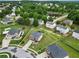 Aerial view of a two-story brick home in a cul-de-sac with a pond nearby at 85 Foxgrove Cv, Covington, GA 30014