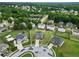 Aerial view of a two-story brick home in a cul-de-sac with a pond nearby at 85 Foxgrove Cv, Covington, GA 30014