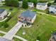 Aerial view of a two-story brick home with a well-manicured lawn and a two-car garage at 85 Foxgrove Cv, Covington, GA 30014