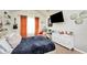 Cozy bedroom with blue comforter, cream walls, vaulted ceiling and decorative curtains at 85 Foxgrove Cv, Covington, GA 30014