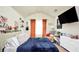 Cozy bedroom with blue comforter, cream walls, vaulted ceiling and decorative curtains at 85 Foxgrove Cv, Covington, GA 30014