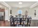 Elegant dining room with modern chandelier, stainless steel refrigerator, and hardwood floors at 85 Foxgrove Cv, Covington, GA 30014