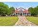 Inviting one-story home with a red roof, long stone walkway, covered porch, and a well-maintained front yard at 85 Foxgrove Cv, Covington, GA 30014