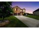 Two-story brick home featuring a two-car garage, well-manicured lawn, and a concrete driveway at 85 Foxgrove Cv, Covington, GA 30014