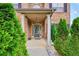 Charming front porch with brick facade, covered entryway, and manicured shrubs at 85 Foxgrove Cv, Covington, GA 30014