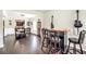 Open living area with a bar, dining room, and hardwood floors, perfect for entertaining guests at 85 Foxgrove Cv, Covington, GA 30014