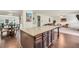 Open-concept area featuring a kitchen island, dining area, and living space with hardwood floors at 85 Foxgrove Cv, Covington, GA 30014