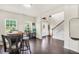 Inviting entryway with hardwood floors, a staircase, and a view of the open living spaces at 85 Foxgrove Cv, Covington, GA 30014