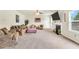 Spacious living room features a fireplace, plush seating, and a ceiling fan for added comfort at 85 Foxgrove Cv, Covington, GA 30014