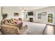 Spacious living room with neutral carpet, a fireplace, and ample natural light at 85 Foxgrove Cv, Covington, GA 30014