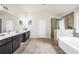 Large bathroom with double sinks, a separate shower, and tub offers luxury and convenience at 85 Foxgrove Cv, Covington, GA 30014