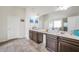 Spacious bathroom featuring double sinks, large mirror, and tiled floors at 85 Foxgrove Cv, Covington, GA 30014