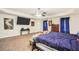 Open main bedroom with TV and soft carpet flooring with bright window at 85 Foxgrove Cv, Covington, GA 30014