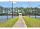 Outdoor tennis courts surrounded by fencing, with a pathway leading to a covered shelter at 85 Foxgrove Cv, Covington, GA 30014