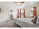 Cozy bedroom with carpet, a ceiling fan, two windows, and a comfortable looking bed at , Atlanta, GA 30318