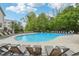 Relaxing community pool surrounded by lounge chairs and lush greenery at , Atlanta, GA 30318