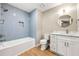 Modern bathroom featuring a tub with a tiled wall and a vanity with a round mirror at 2300 Newport Lndg, Atlanta, GA 30009
