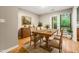Bright dining room featuring hardwood floors, and a wooden table, with beautiful backyard view at 2300 Newport Lndg, Atlanta, GA 30009