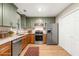 Updated kitchen featuring stainless steel appliances, two-tone cabinetry, and wood flooring at 2300 Newport Lndg, Atlanta, GA 30009