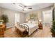 Neutral main bedroom featuring a ceiling fan, hardwood flooring, and ensuite bathroom at 2300 Newport Lndg, Atlanta, GA 30009