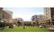 A vibrant town square featuring modern buildings and an open green space filled with people enjoying the outdoor area at 2300 Newport Lndg, Atlanta, GA 30009