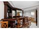 Wet bar with rich wood finish, seating and glass shelving at 272 14Th St # 23, Atlanta, GA 30309
