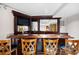 Wet bar with rich wood finish, seating and television at 272 14Th St # 23, Atlanta, GA 30309