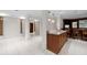 Basement featuring ceramic tile flooring, support columns, and custom wet bar with seating at 272 14Th St # 23, Atlanta, GA 30309
