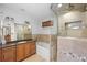 Luxurious bathroom with a walk-in shower, a soaking tub, and a granite countertop vanity at 272 14Th St # 23, Atlanta, GA 30309