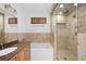 Elegant bathroom with a granite countertop vanity, soaking tub, and a frameless glass walk-in shower at 272 14Th St # 23, Atlanta, GA 30309