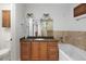 Stylish bathroom featuring a granite countertop vanity, a soaking tub, and decorative tile accents at 272 14Th St # 23, Atlanta, GA 30309