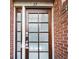 Exterior front door of residence surrounded by brick wall at 272 14Th St # 23, Atlanta, GA 30309